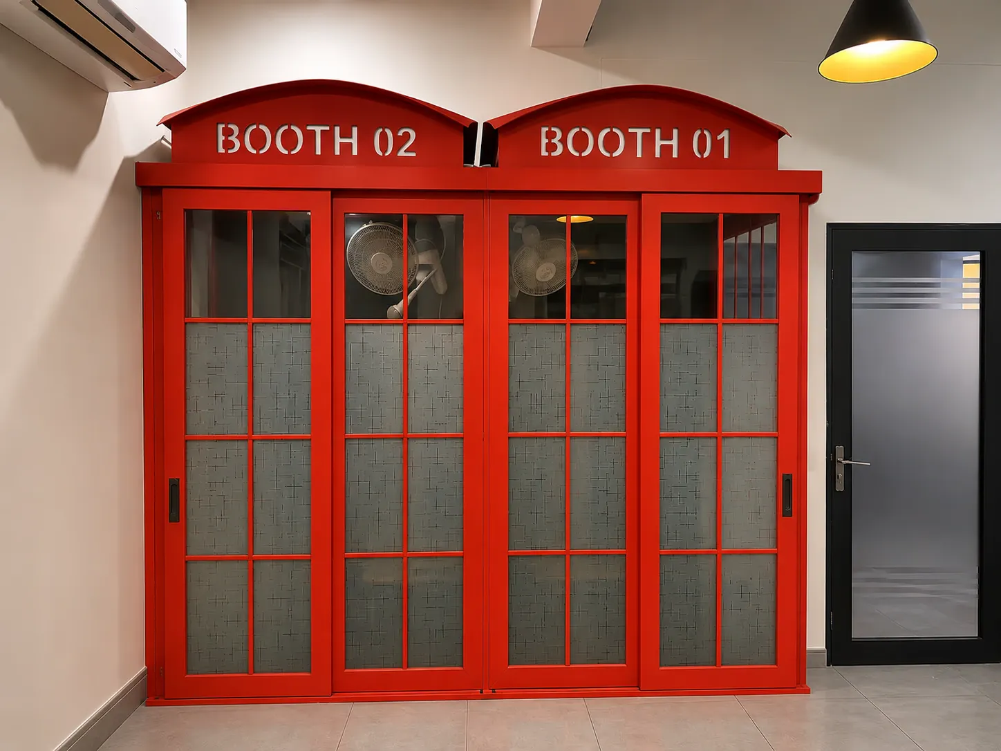 The red calling booths at WorkBench, marked Booth 01 and Booth 02