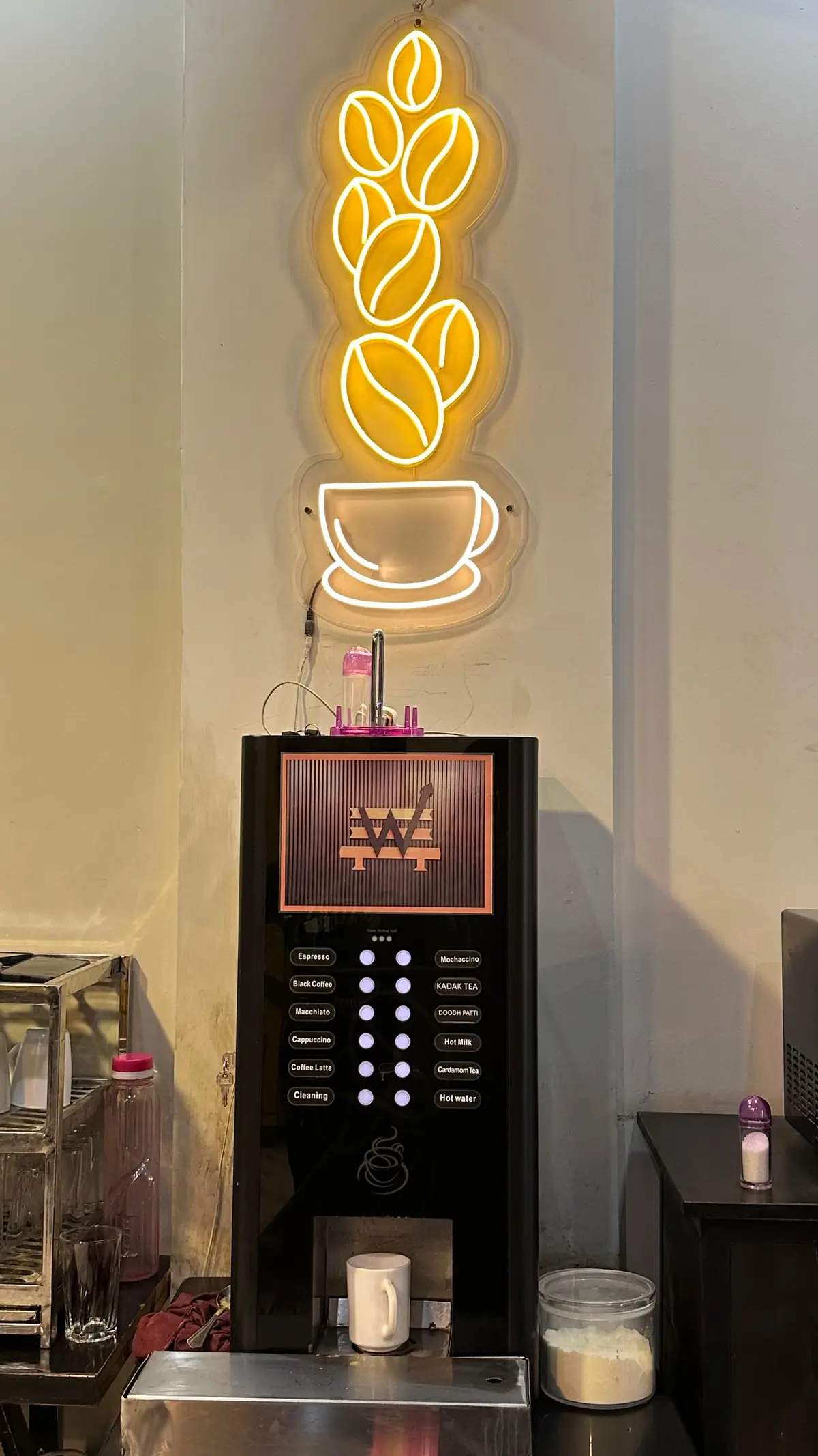 Neon signage glowing on the wall inside WorkBench in Lahore
